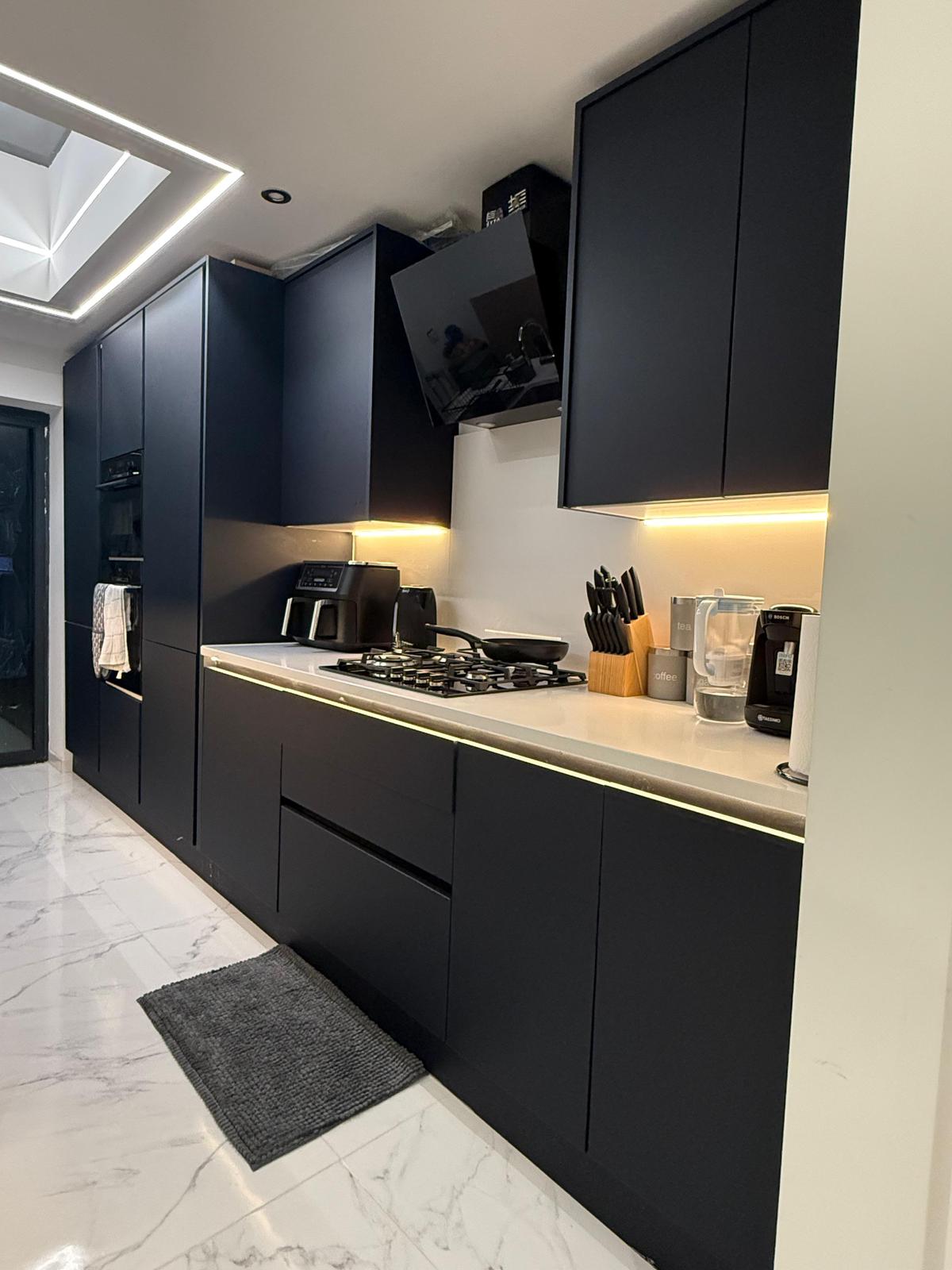 Kitchen extension project featuring open-plan kitchen-diner with natural light and modern bi-fold doors